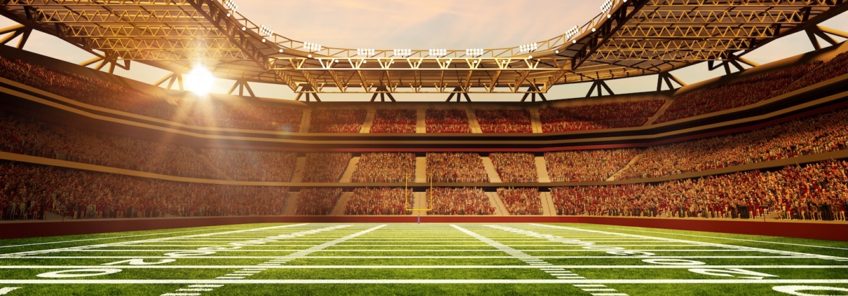 American football stadium with sunrise behind the stands