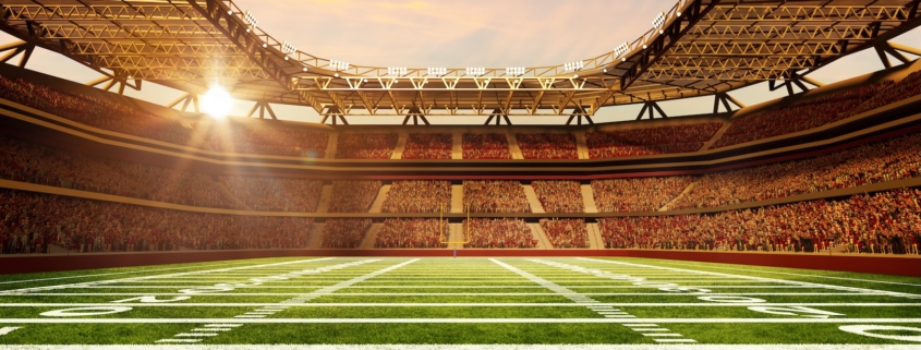 American football stadium with sunrise behind the stands